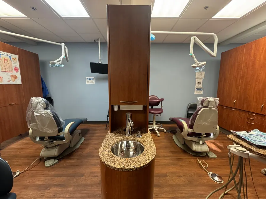 A treatment bay with blue and maroon chairs