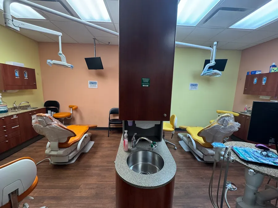 A treatment bay with orange and yellow chairs